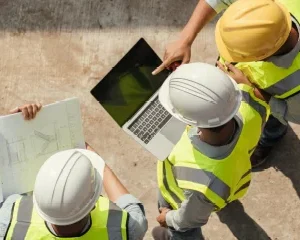 Construction professionals collaborating on a job site, representing ACI Carolinas Corporate Membership for concrete industry companies.