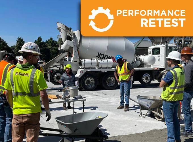 Concrete certification candidates completing a hands-on performance retest at an ACI Carolinas field testing event with a ready-mix concrete truck.