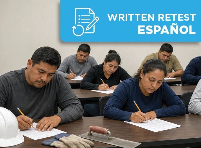 Latino concrete construction professionals taking a Spanish written retest in a classroom with hard hats and flatwork tools nearby.